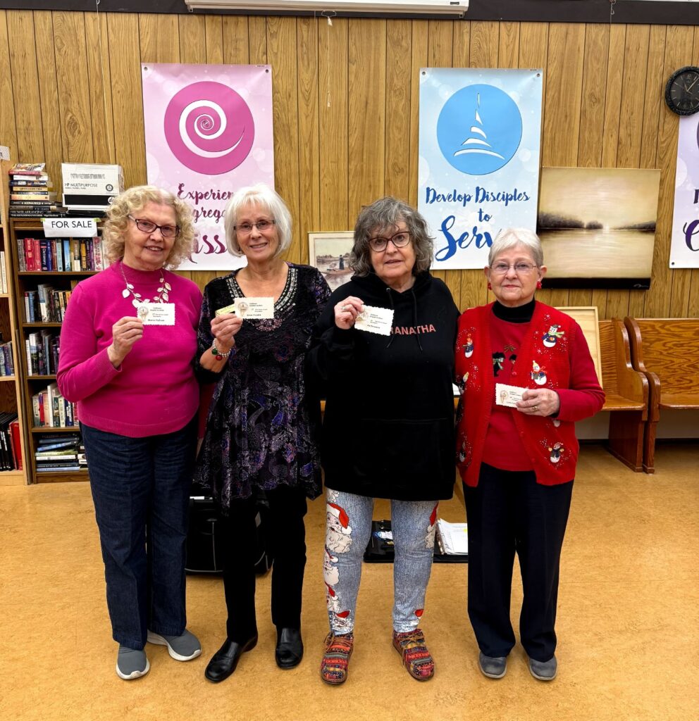 Service award pins to long serving members: Sharon with 15 years, Karen with 15 years, Pat with 10 years and Lynne with an amazing 40 years.